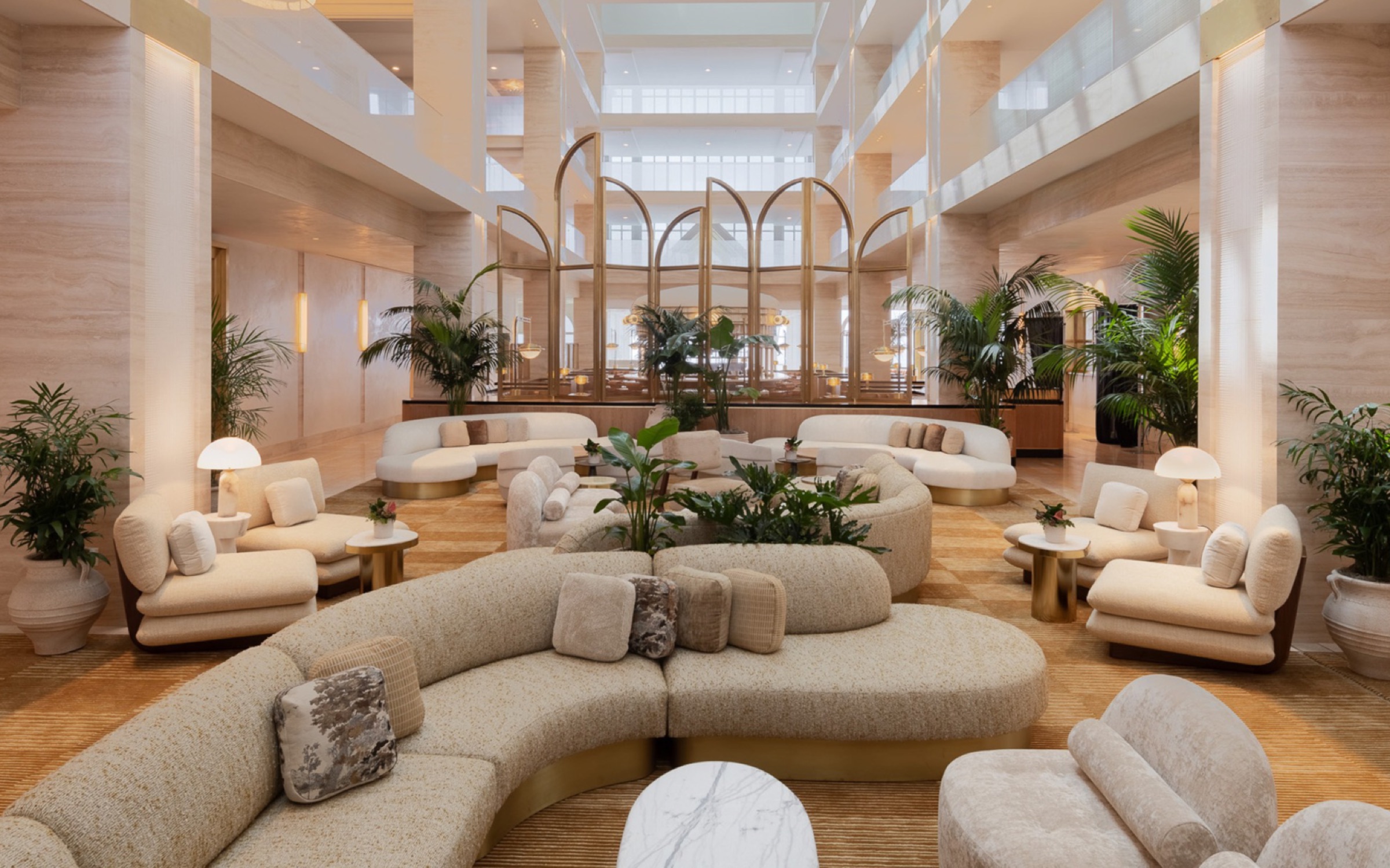A refined hospitality interior featuring expansive natural stone walls and columns